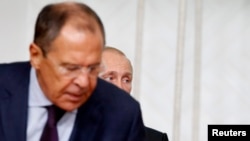 Russian Foreign Minister Sergei Lavrov (front) and President Vladimir Putin at a signing ceremony in Mongolia on September 3