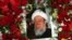 The portrait of former Afghan President Sibghatullah Mojaddedi is seen in the wreath of flowers during his funeral procession at the presidential palace in Kabul, February 13, 2019