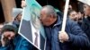 A supporter of Vladimir Putin kisses his portrait in Belgrade during the Russian president's visit to the Serbian capital on January 17.
