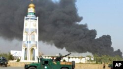 Afghan security forces arrive after a powerful explosion outside the provincial police headquarters in Kandahar on July 18.