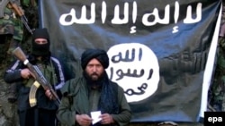 An image made released by the Islamic State (IS) on January 27 purportedly showing Hafiz Said Khan (C) head of the IS branch in Pakistan and Afghanistan.