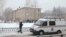 A vehicle from the Russian Emergencies Ministry stands parked near a local school in Perm after two assailants wearing masks injured schoolchildren and a teacher with knives on January 15. 