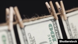 Generic -- Hundred Dollar Bills Hanging From a Clothesline on a Dark Background.