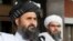 FILE: The Taliban negotiating team has been led by Mullah Abdul Ghani Baradar (L), who co-founded the movement with the late Mullah Mohammad Omar.