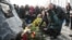 People lay flowers at the new memorial to the victims of Flight PS752 at Boryspil airport.