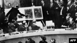 АКШнын расмий өкүлү Кубада СССР жайгаштырган тактикалык ракеталар турган жерлердин абадан тартылган сүрөттөрүн БУУнун Коопсуздук кеңешинин мүчөлөрүнө көрсөтүүдө. 28-октябрь,1962