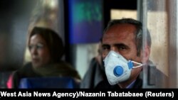 An Iranian man wears a protective masks to prevent contracting coronavirus on a bus in Tehran on February 25.