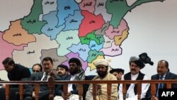 FILE: Members of the loya jirga listen during the first day of a four-day long meeting of around 2,500 Afghan tribal elders and leaders in Kabul (November, 2013).
