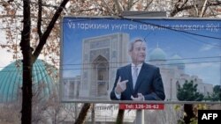 FILE: A giant election poster of President Islam Karimov.