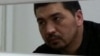 Блогер Ермек Тайчибеков, обвиняемый в "разжигании розни", на скамье подсудимых. Село Кордай Жамбылской области, 4 ноября 2015 года. 