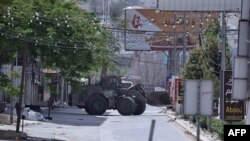 Një buldozer i ushtrisë izraelite duke kaluar nëpër një rrugë të braktisur gjatë një sulmi në qytetin Xhenin, në Bregun e uzurpuar Perëndimor, 21 maj 2024. 