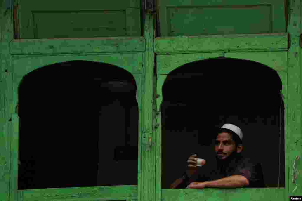 Мужчина держит чашку зеленого чая в чайной лавке в Пешаваре, Пакистан, 22 июля 2025 года. REUTERS/Fayaz Aziz