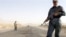 Afghan police guard the Kabul-Kandahar highway 