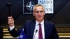 NATO Secretary-General Jens Stoltenberg gestures with a hammer during a NATO defense ministers meeting at the alliance's headquarters in Brussels on October 13.
