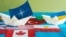 Бумажные кораблики с флагами альянса НАТО и Украины. Иллюстрационный коллаж