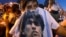 People mourn soccer legend Diego Maradona outside the morgue