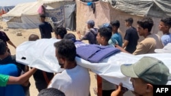 Газада чогулган палестиндер ооруканада иштеп жатканда өлтүрүлгөн беш журналисттин сөөгүн көтөрүп баратышат. 26-август, 2025-жыл. 