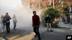 Students take part in a demonstration inside Tehran University on December 30. The recent wave of protests in Iran was initially fueled by economic grievances and mostly young citizens frustrated by an ailing economy and bleak prospects.
