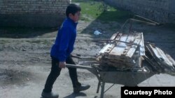 Uzbekistan - school boy is bringing a scrap metal to the school in Jizzakh city, 14 March 2015