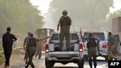 Pakistani soldiers arrive to take position outside the Pakistan Air Force base after an attack by militants near Peshawar on September 18.