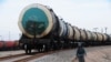 FILE: An Afghan policeman patrols alongside a new railway track in Hairatan close to the northern border of Afghanistan with Uzbekistan. 