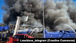 Firefighters work to extinguish a blaze following a Russian aerial strike in Kyiv on September 16. 