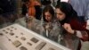Journalists look at ancient clay tablets that were returned to Iran from the United States at the National Museum in Tehran in 2019.