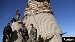 Afghan National Army (ANA) soldiers stand guard at the check post in Khawaja Omari district of Ghazni province on April 12.