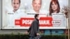 BOSNIA-HERZEGOVINA -- A man walks next to an election campaign poster in Sarajevo, November 10, 2020