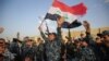 Iraqi federal police dance with civilians and an Iraqi flag to celebrate success against Islamic State fighters in Mosul on July 2, 2017.