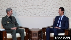 Iranian Defense Minister Amir Hatami (left) meeting with Syrian President Bashar al-Assad in Damascus on August 26. 