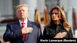 U.S. President Donald Trump and first lady Melania Trump observe a moment of silence to mark the 18th anniversary of the September 11 attacks on the South Lawn of the White House in Washington.
