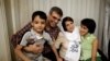 Nasrin Sotoudeh (second from right) poses with her husband, Reza Khandan, her son Nima, and her daughter Mehraveh at her house in Tehran in September 2013.