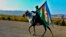 An Azerbaijani soldier with a national flag rides a horse in Ganca, Azerbaijan's second-largest city, near the border with Armenia, on November 10.