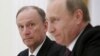 Russia -- Russian Security Council Secretary Nikolai Patrushev (L) looks at President Vladimir Putin during a meeting with the BRICS countries' senior officials in charge of security matters at the Kremlin in Moscow, Russia, May 26, 2015