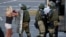 BELARUS -- Belarusian law enforcement officers detain a participant in a protest against the results of the 2020 Belarusian presidential election, in Minsk, August 11, 2020