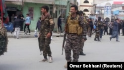 Afghan security forces keep watch near the site of a suicide bombing in Kabul on March 9.