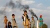 Afghan children stand by a brick-making factory on the outskirts of Jalalabad on November 13.