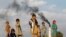Afghan children stand by a brick-making factory on the outskirts of Jalalabad on November 13.