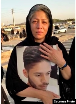 Mahboobeh Ramezani holds a photo of her slain son.