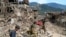 EDITORS NOTE: Graphic content / Afghans walk past damaged houses, after earthquakes at Mazar Dara village in Nurgal district, Kunar province, in Eastern Afghanistan, on September 1, 2025.