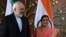 Indian Foreign Minister Sushma Swaraj (right) poses for photos with Iranian Foreign Minister Mohammad Javad Zarif prior to a meeting in New Delhi on May 14. 