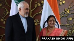 Indian Foreign Minister Sushma Swaraj (right) poses for photos with Iranian Foreign Minister Mohammad Javad Zarif prior to a meeting in New Delhi on May 14. 