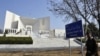 FILE: a soldier walks past the Pakistani Supreme Court building.