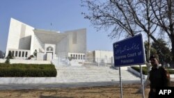 FILE: a soldier walks past the Pakistani Supreme Court building.