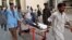 A boy who was injured in a roadside bomb blast is brought to a local hospital in Quetta, Balochistan Province on August 11. 