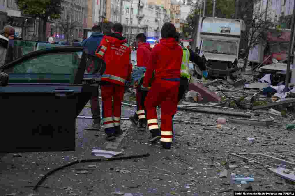 Медичні працівники несуть постраждалу людину у центральній частині Києва