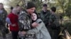 A Russian recruit and his wife embrace at a railway station in Prudboi, in Russia's Volgograd region, in September 2022 after President Vladimir Putin announced a partial mobilization.