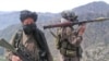 Taliban fighters patrol outside the Swat Valley near Buner district.