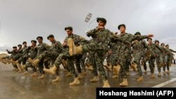 Afghan National Army (ANA) soldiers march during a training exercise of a graduation ceremony at a training center in the western Herat province on April 15.